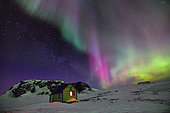 Hut under Aurora borealis, Cape Sawainson, north-east coast of Greenland