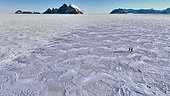 Hikers on the pack ice, in the background the islands of Rathbone (left) and Rafles (right), East Coast of Greenland