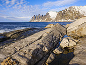 Coastal landscape at Tungeneset and the peaks Okshornan (devils teeth). The island Senja during winter in the north of Norway. Europe, Norway, Senja, March