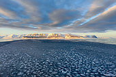 A landscape of pack ice (pancake ice) and mountains of sedimentary origin in Billefjord in Spitsbergen, Svalbard archipelago.