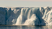 Imposing waterfall (Glacial stream) at the front of the Brasvellbreen ice cap in the North-East Land, Svalbard archipelago