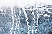 Abstract drawings of snow and ice on a bluish glacier on the east coast of Spitzbergen Island, Svalbard archipelago.
