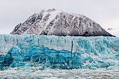 Bluish Lillihook Glacier in La Croix Bay against a backdrop of snow-capped mountains, Spitsbergen Island, Svalbard Archipelago