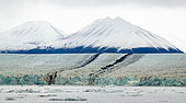 Median moraines of Brepollen (a Hornsund glacier) against a background of snow-capped mountains, Spitsbergen island, Svalbard archipelago