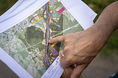 Woman pointing to unacquired plots of land as part of the controversial project to bypass the communes of Le Pertuis and Saint Hostien, taking the N88 through various natural areas. The route is criticised by opponents of the Lutte des sucs and environmentalists, Le Pertuis, France.
