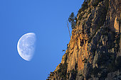 Gibbous moon and granite massif in Corsica. Tre Signore massif above Porto in southern Corsica