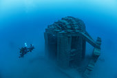 Diver cameraman in front of the largest artificial reef ever built for scuba diving (printed in 3D concrete), in the Marine Protected Area of the Agatha coast. This is the first time in the world that such a structure has been submerged. The reef is located off Cap d'Agde, 3 km from the coast, at a depth of 20 m. The module weighs 105 tonnes, measures 6.50 m high, 8 m long and 6 m wide, and offers 430 m3 of diving volume. Immersion will take place in July 2022, as part of the Recif'lab program, supported by the Aire Marine Protégée de la côte agathoise.