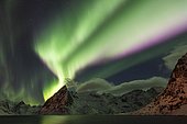 Northern lights over snow-capped mountains, Hamnoy, Lofoten, Norway, Europe