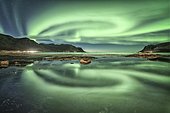 Aurora borealis reflected in the sea, Vågan, Lofoten, Nordland, Norway, Europe
