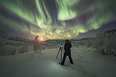 Photographer taking pictures of Northern Lights, Aurora Borealis, Kilpisjärvi, Lapland, Finland, Europe