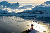 Skier looking out over the Nuuk fjord, Greenland