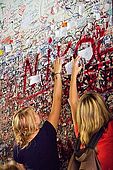 Girls leaving love messages at the entrance to Juliet's House, Verona, Veneto, Italy
