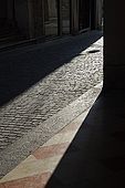 Sunlight filters through the narrow streets of Bassano del Grappa, Veneto, Italy