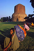 Ladies gardening at the foot of the Dhamekh stupa. The stupa signs the place where the Buddha once started his predication.