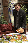 Waiter and selection of traditional salads, Riad El Yacout, traditional Moroccan riad, Fes, Morroco. Property released.