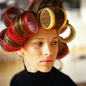 Young woman with rollers in hair