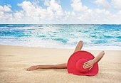 Hawaii, Woman laying on the beach in remote tropical location.