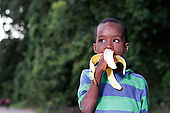 happy little boy eating a banana.