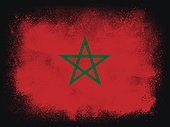 Morocco Flag design composition of exploding powder and paint, isolated on a black background for copy space. Colorful abstract dust particles explosion. World cup 2022 football symbol for printing