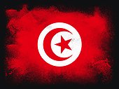 Tunisia Flag design composition of exploding powder and paint, isolated on a black background for copy space. Colorful abstract dust particles explosion. World cup 2022 football symbol for printing