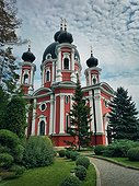 Curchi Monastery outdoor view of the famous landmark in Orhei, Moldova. Christian Orthodox style church tradional for eastern Europe culture. Beautiful garden with trees around the basilica