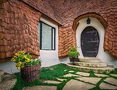 The Clay Castle from the Valley of Fairies, a touristic complex in Transylvania, Romania. Closeup view to a tiny entrance door, fantasy dwarf house from tales