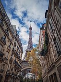 Eiffel tower as seen through the parisian buildings. Snenery autumn season in Paris, France.