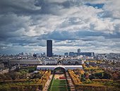 Scenery view from the Eiffel tower height to the Paris cityscape, France. Montparnasse tower and Les Invalides seen on the horizon
