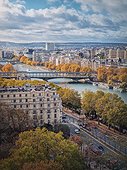 Aerial view of Paris city, France. Scenery fall season cityscape with yellow trees along Seine riverbank