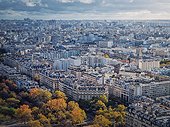 Paris cityscape view from the Eiffel tower height, France. Fall season scene with colored trees