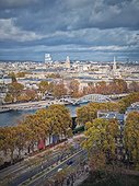 Aerial view of Paris city, France. Autumnal cityscape with colorful trees along Seine river