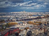 Panoramic view over the Paris city to the Sacre Coeur de Montmartre basilica on the hill, France. Autumn parisian cityscape