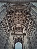 View underneath triumphal Arch (Arc de triomphe) in Paris, France. Architectural details of the famous historic landmark