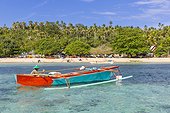Local fisherman in outrigger boat in the shallow reefs off Bangka Island, off the northeastern tip of Sulawesi, Indonesia, Southeast Asia, Asia