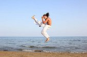 Capoeira dancer on the beach