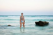 Young woman standing in sea, Grande Cenote, Quintana Roo, Tulum, Mexico