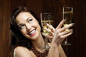 Young woman holding two champagne flutes