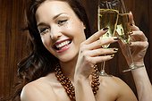 Young woman holding two champagne flutes