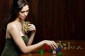 Young woman gambling with playing cards
