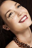 Young woman with diamonds on face, portrait