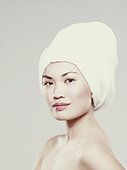 Young woman with hair wrapped in towel