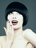 Young woman with black bob gasping