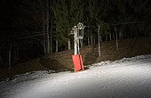 Ski lift on ski slope at night