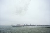 North Sea and Port of Rotterdam during storm with snowfall, Netherlands
