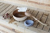 Bowl with ladle and massager in a sauna