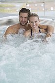 Portrait of a smiling couple in a hot tub