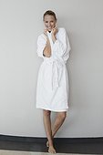 Portrait of a smiling woman in bathrobe at spa