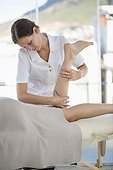 Woman receiving leg massage from a massage therapist