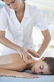 Woman receiving back massage from a massage therapist