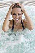 Portrait of a beautiful smiling woman in a hot tub